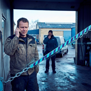 Dansk operationsleder ved åben serviceindgang; gulvbaner i cyan og indigo mødes ved tærskel; varevogn i baggrund; indigo skygger og cyan/green signalreflekser; beslutsomt, anspændt øjeblik.